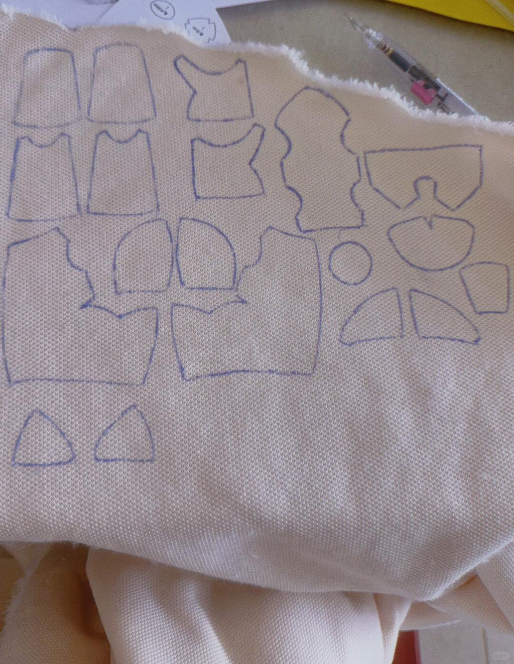 Fabric with blue traced patterns on a beige background