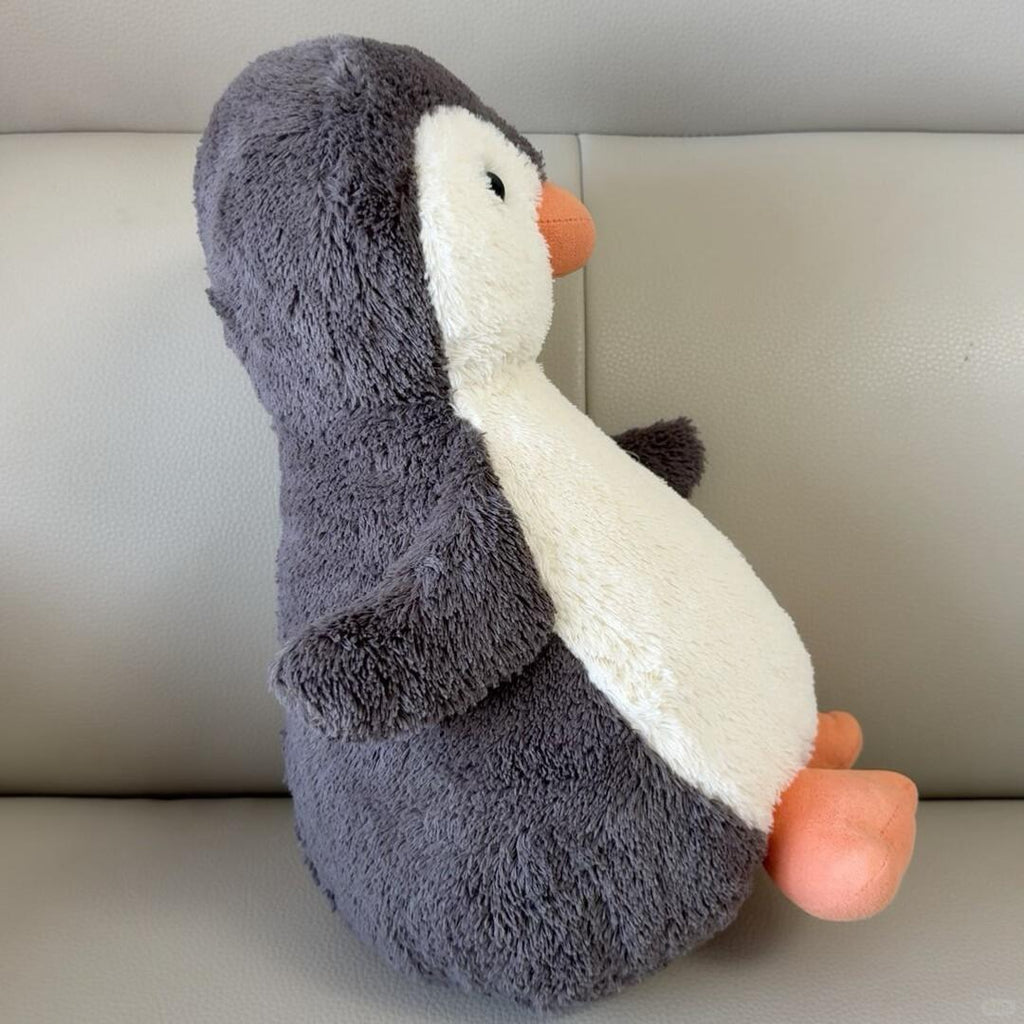 Peanut Penguin sewing process with cut fabric pieces arranged for assembling the plush body