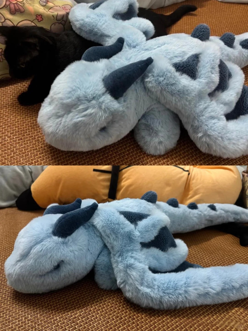 Plush dragon toy on a textured surface with a black dog partially visible.