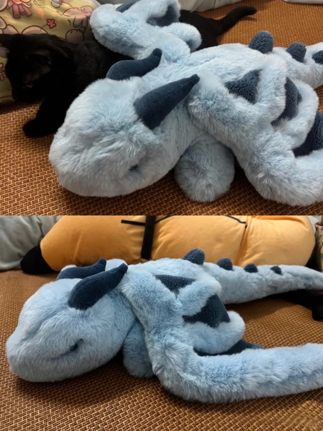 Plush dragon toy on a textured surface with a black dog partially visible.