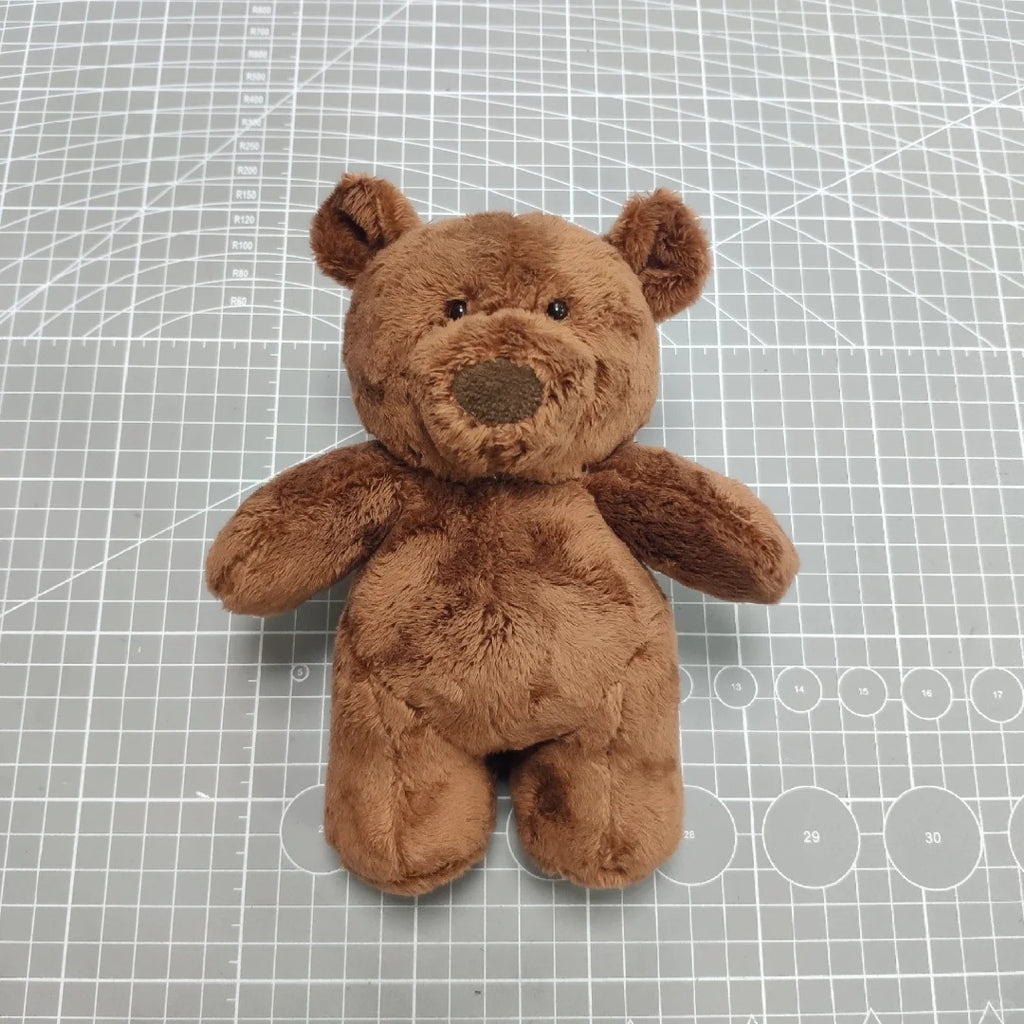 Brown teddy bear on a grid background