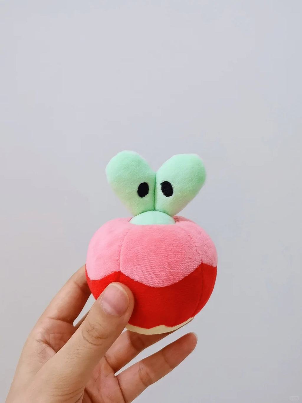 Applin Pokemon plush sewing pattern – green Applin plush close-up front view with black eyes