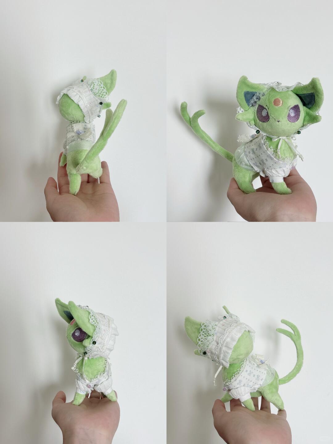 A four-panel photo showing a small green plush Pokémon eevee creature doll being held in a person's hand against a plain white wall. The doll has large ears, purple eyes, a pink forehead mark, and a white lace-like outfit.