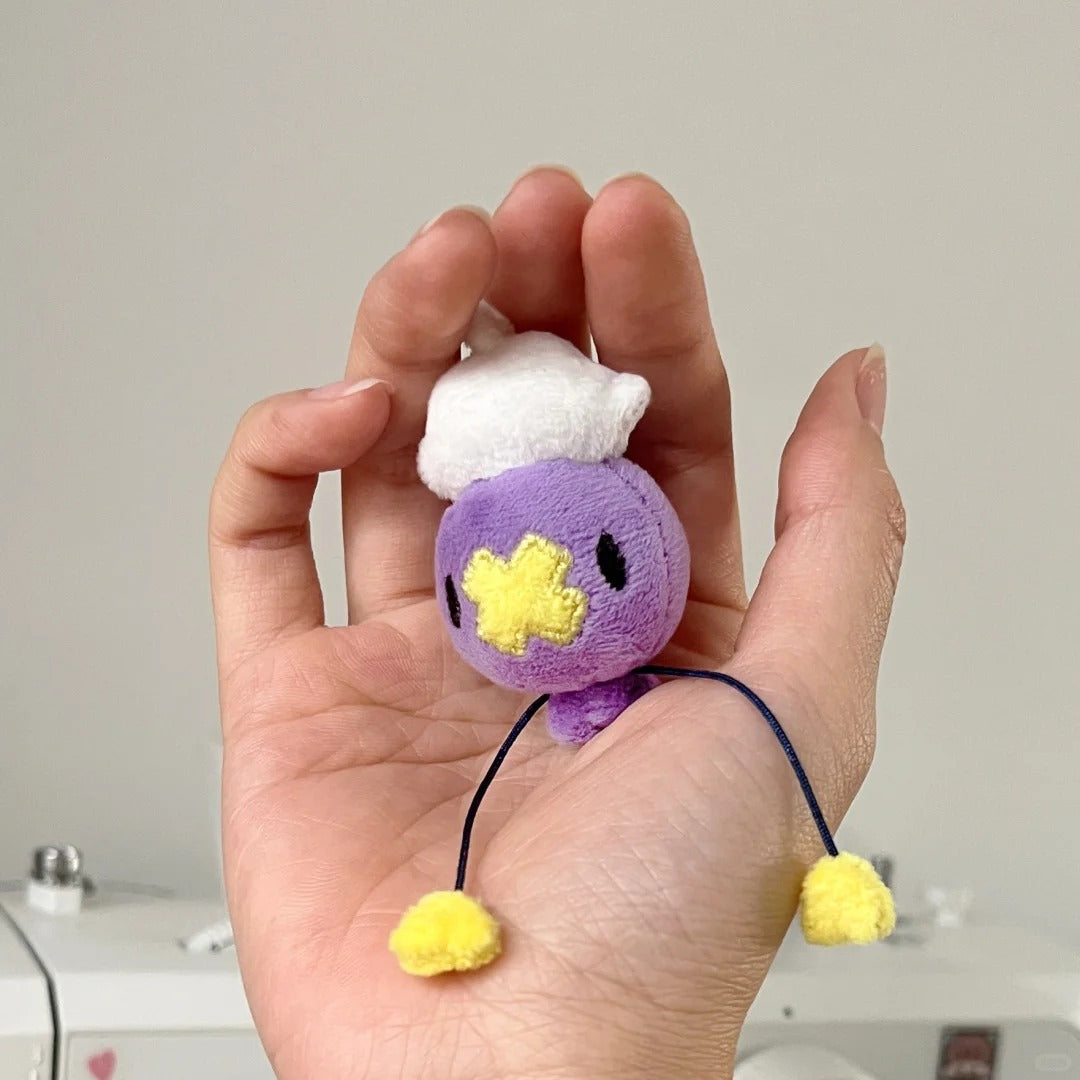 Tiny palm-sized Drifloon plush showing a miniature bag-charm scale