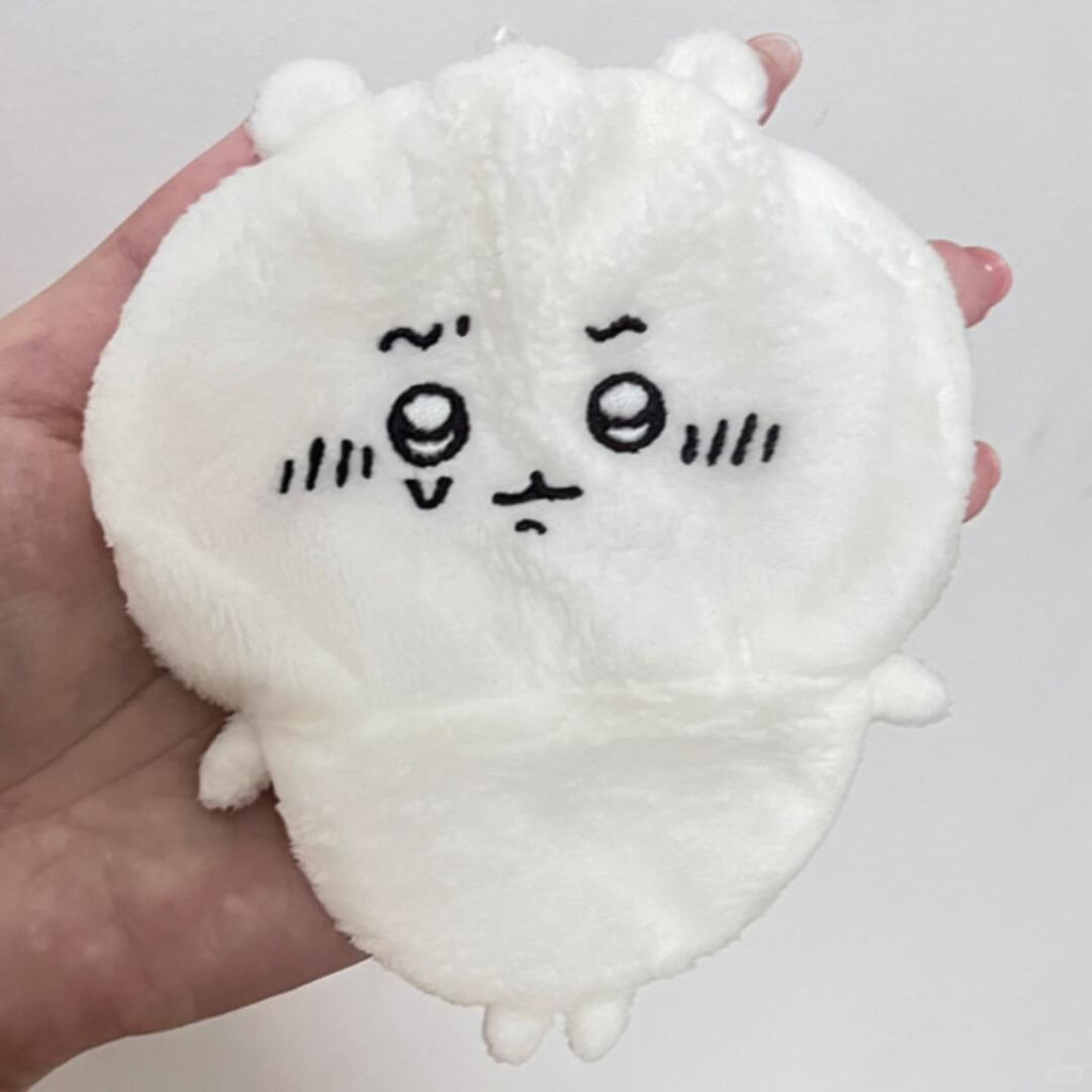 Round white Chiikawa plush held from the front