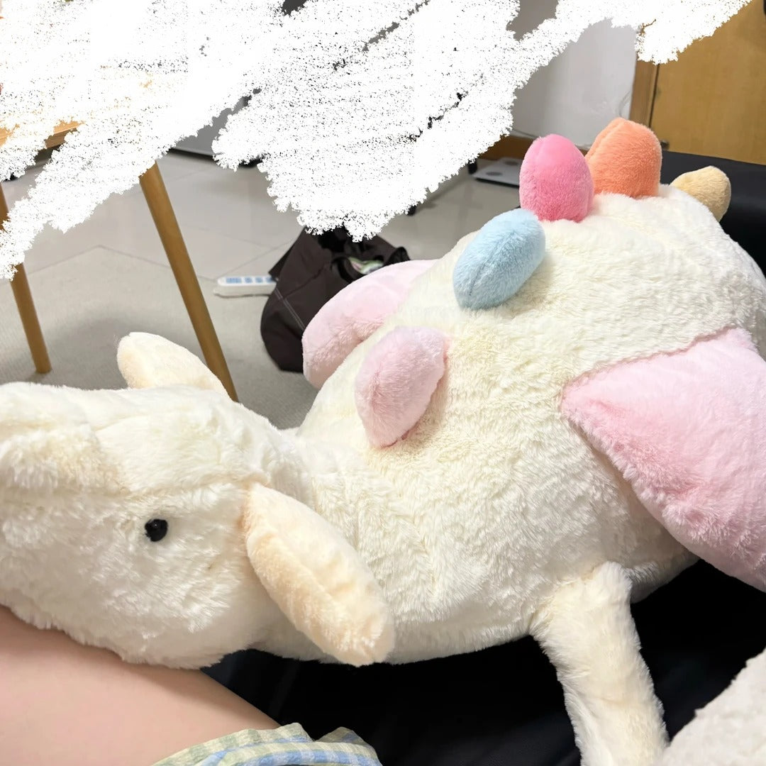 Close-up side view of cream Sky Dragon plush sewing pattern sample with pink wings and pastel spines