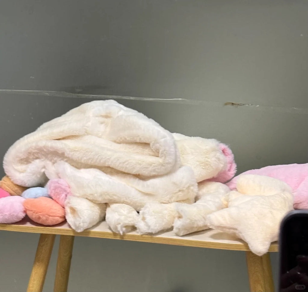Unstuffed Sky Dragon sewing pattern fabric pieces with pink wings and pastel spines laid out for sewing