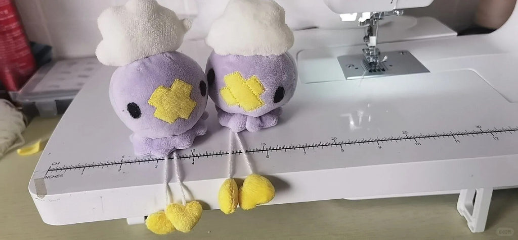 Two finished Drifloon plushies displayed on a sewing machine ruler