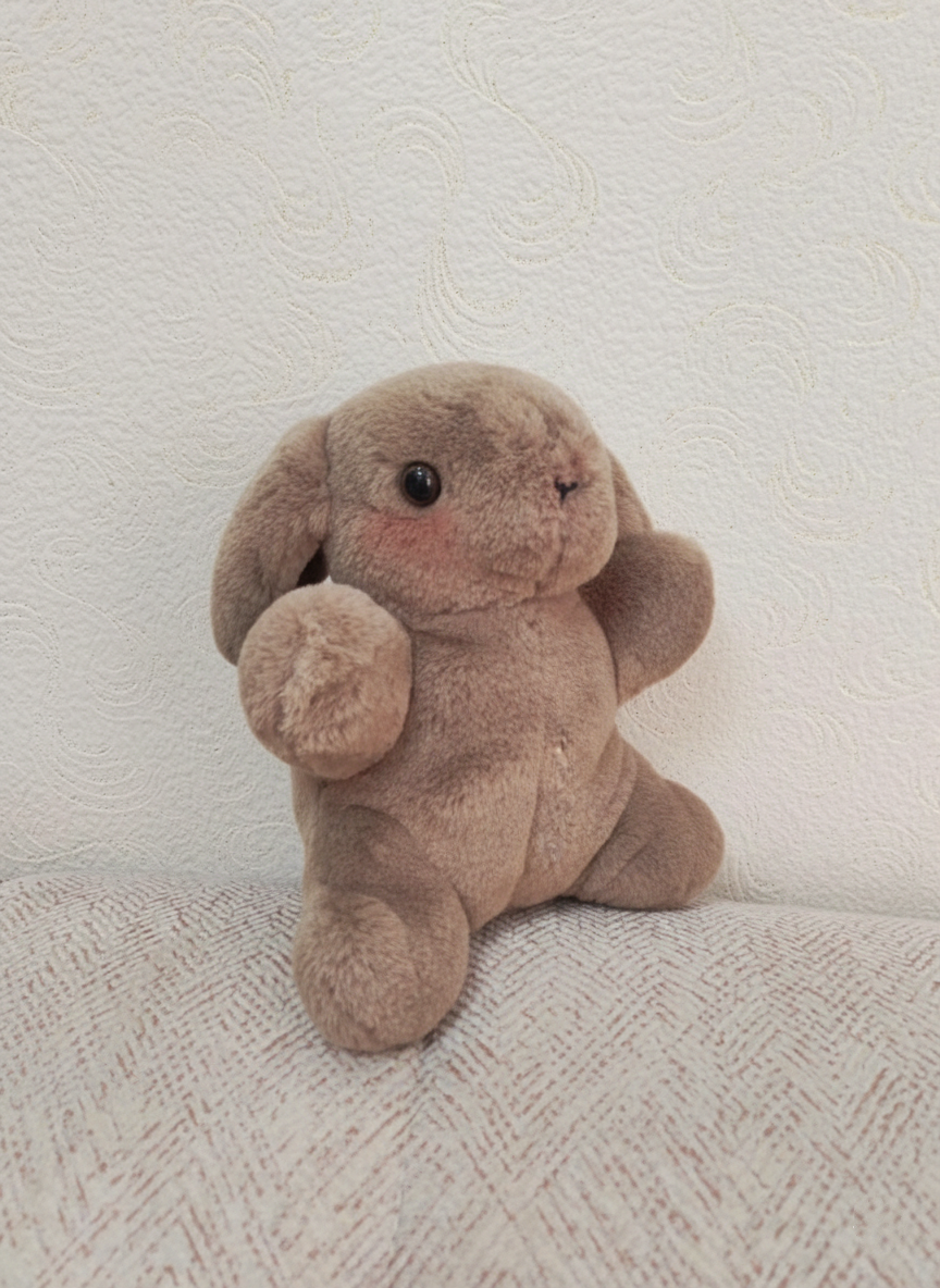 Plush toy rabbit on a textured white surface