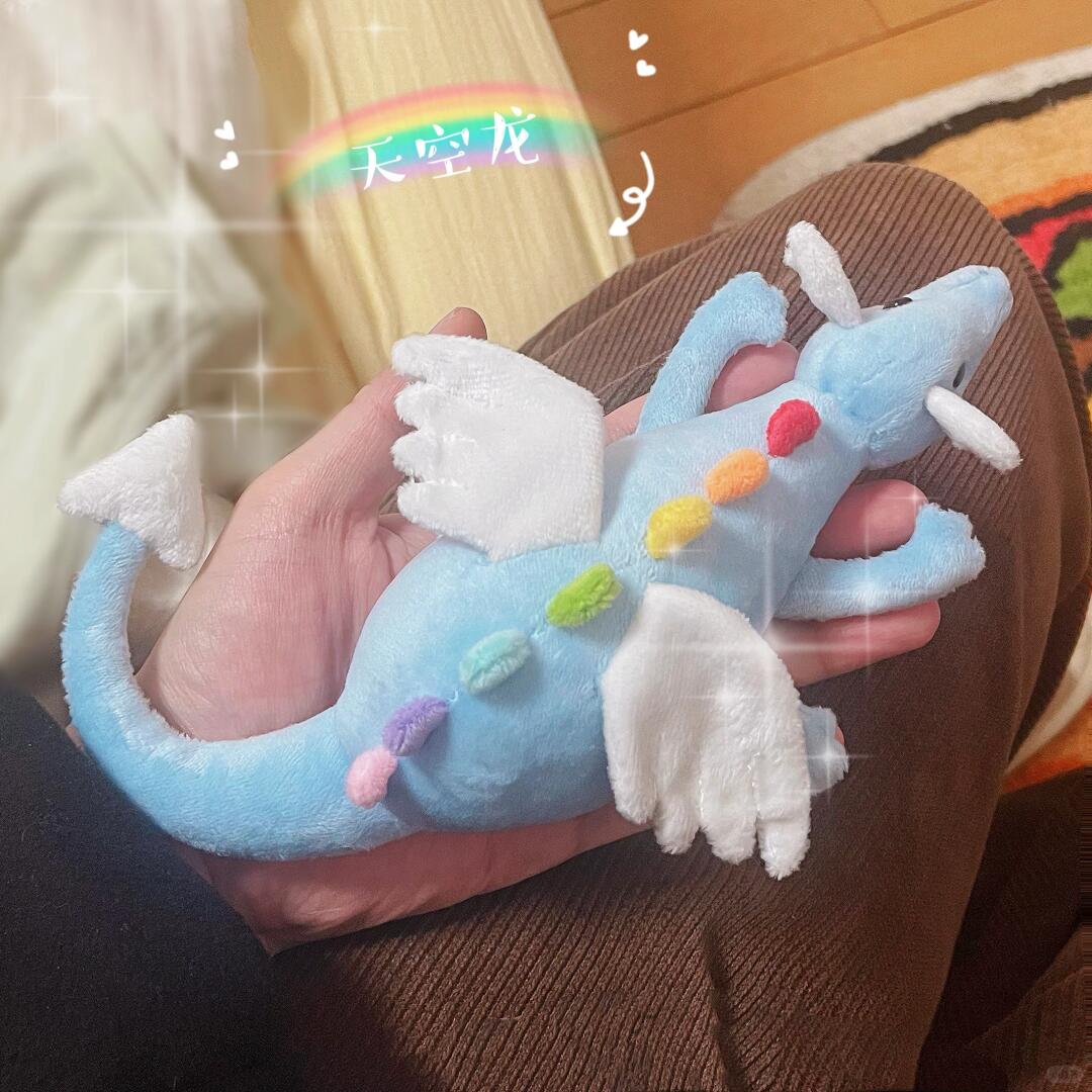 Palm-sized blue Sky Dragon plush made from the PDF sewing pattern resting in hands