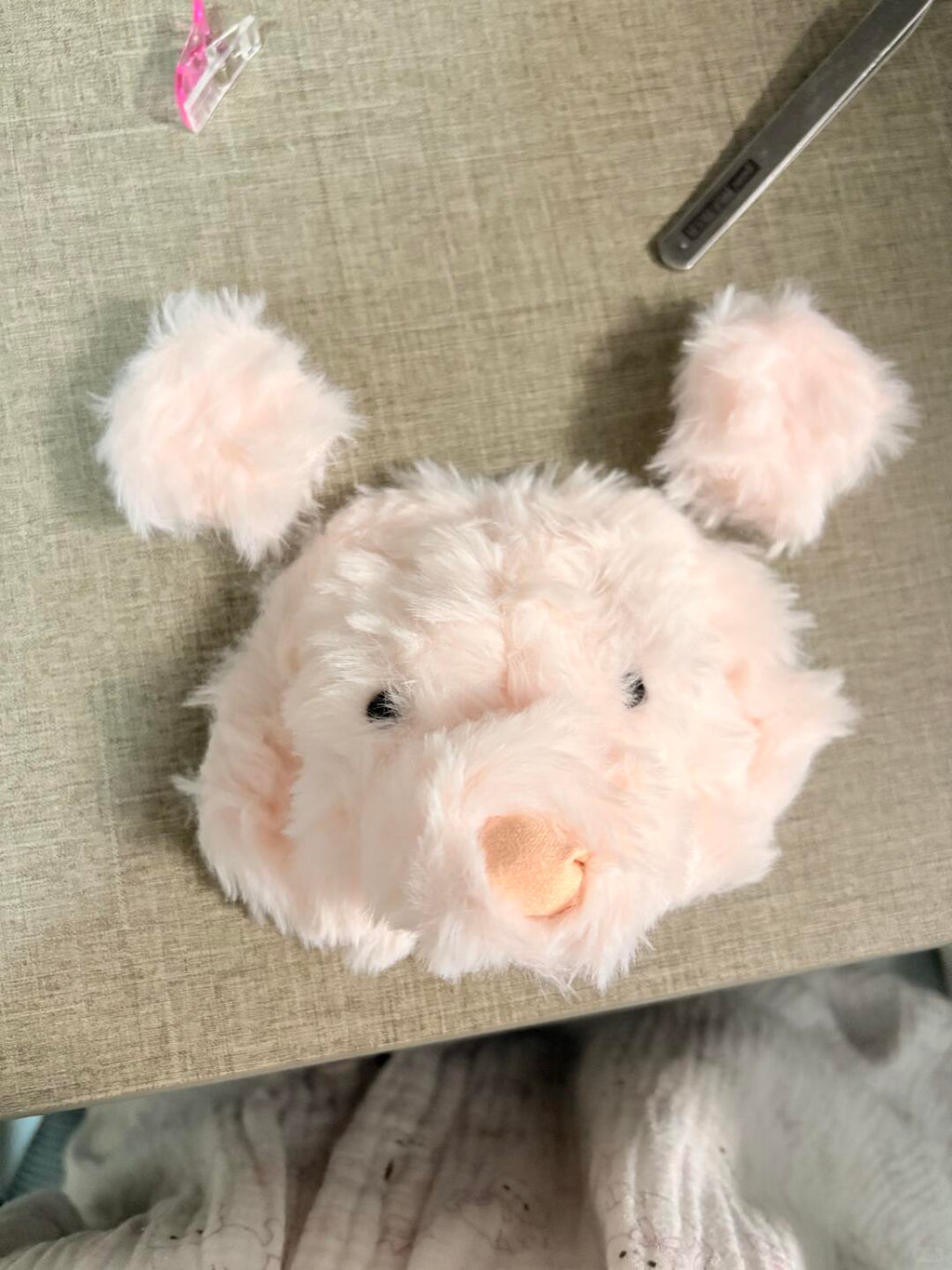 Plush toy bear on a textured surface