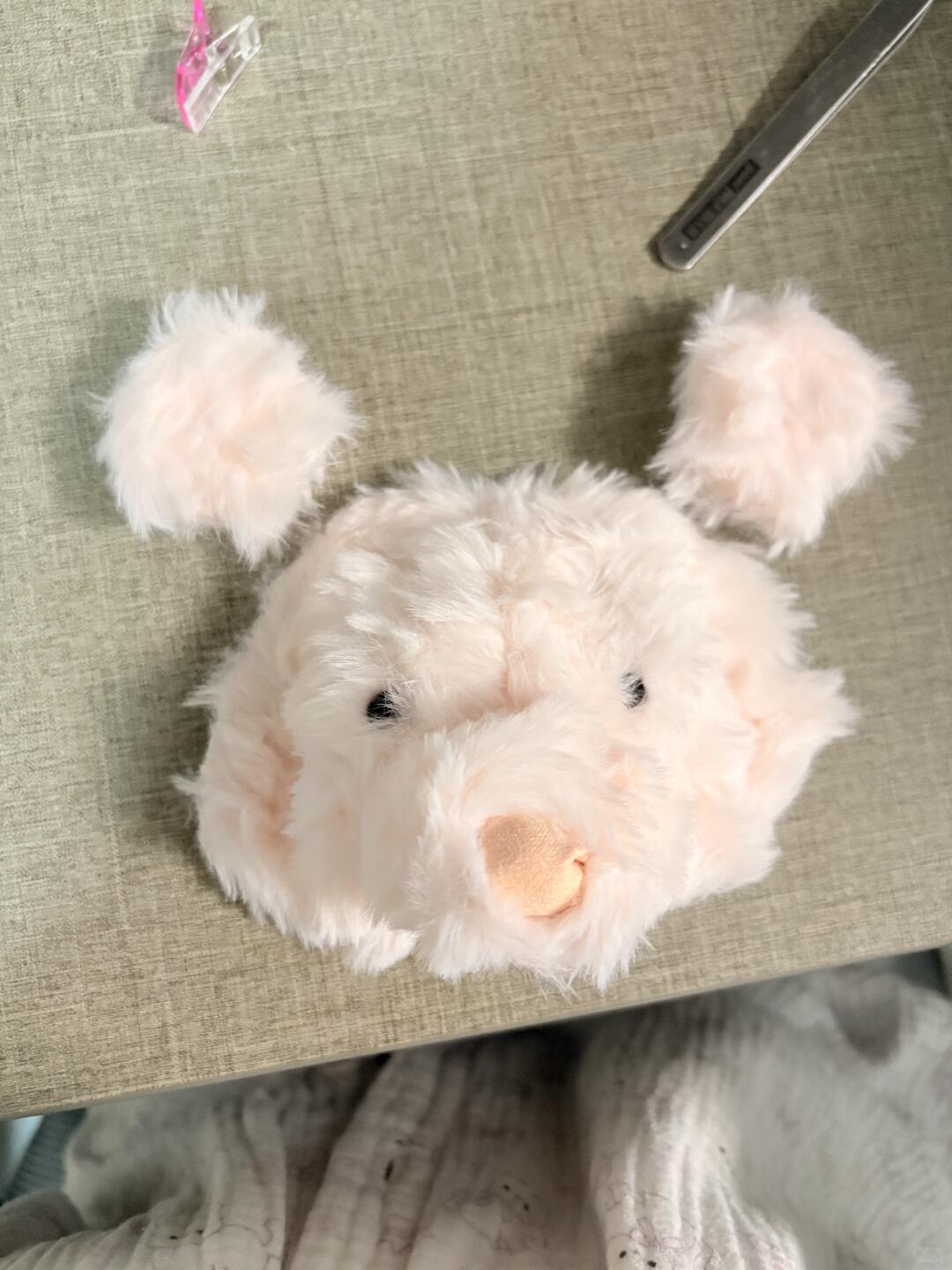 Plush toy bear on a textured surface