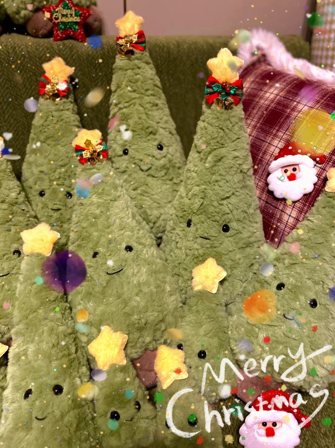 Green plush Christmas trees with festive decorations on a green background.