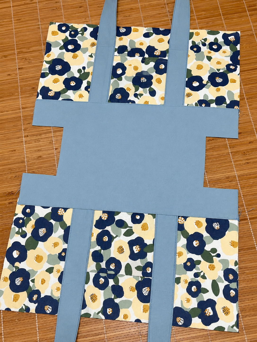 Floral-patterned fabric pieces on a wooden surface