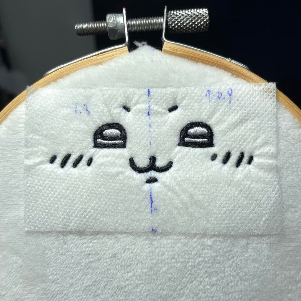 Hachiware plush sewing project with blue ears and white body