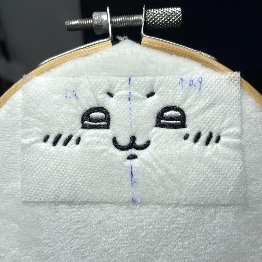 Hachiware plush sewing project with blue ears and white body