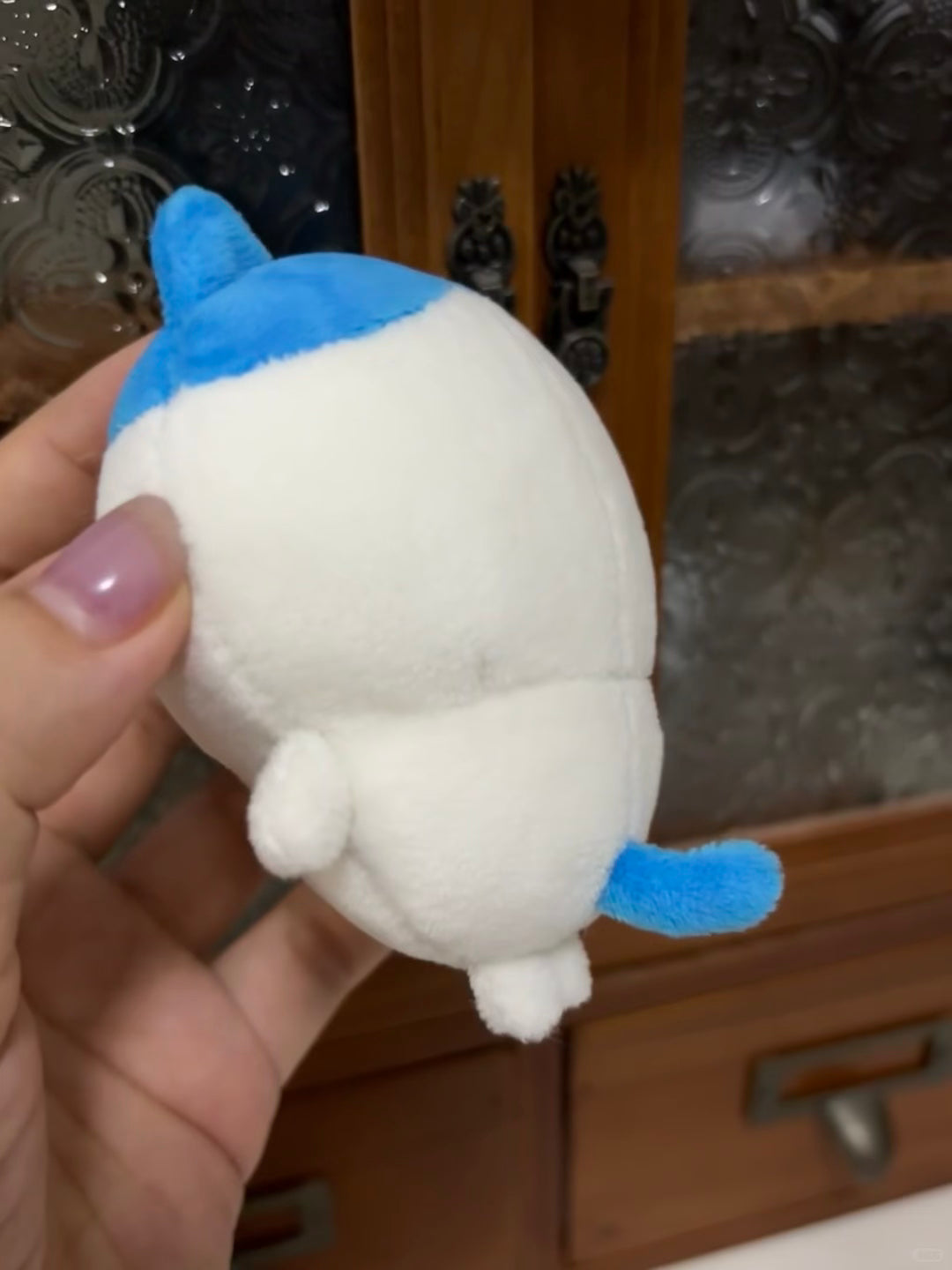 Side view of handmade Hachiware plush showing blue and white fabric