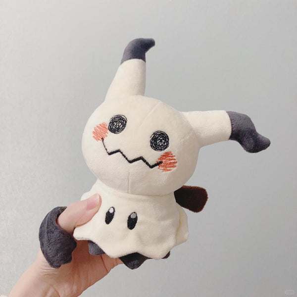 Mimikty Plush toy resembling a ghost with a smiling face held by a hand against a plain background