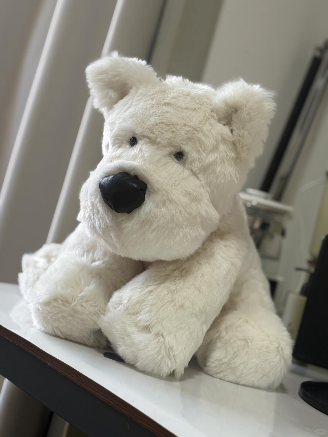 Handmade White scottie dog plushie with a black nose sitting on a surface.