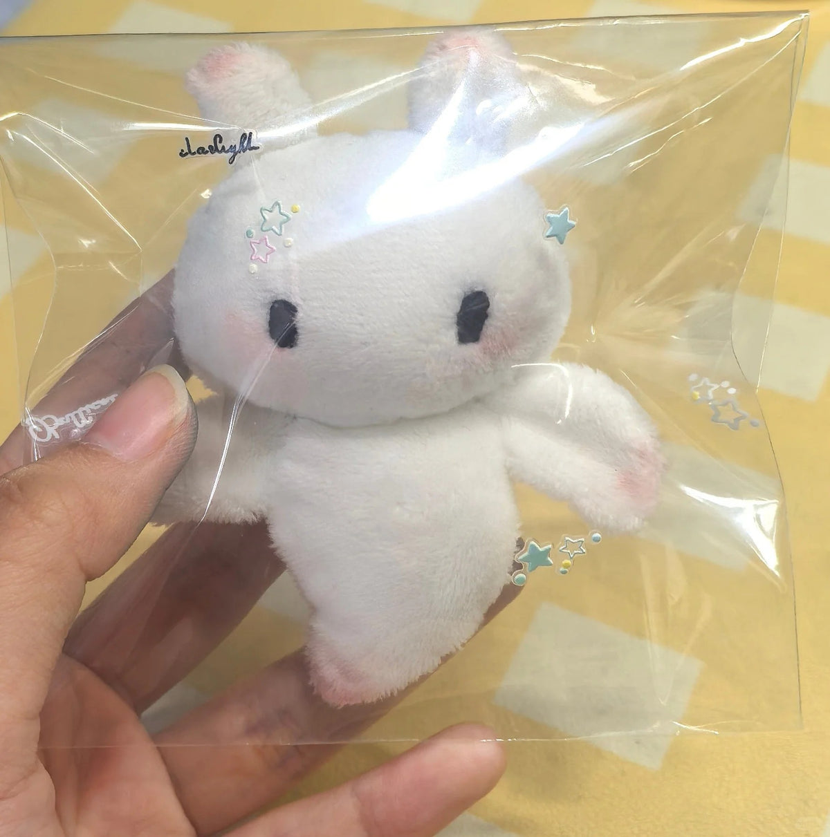 Finished white angel bat plush displayed in a clear gift bag