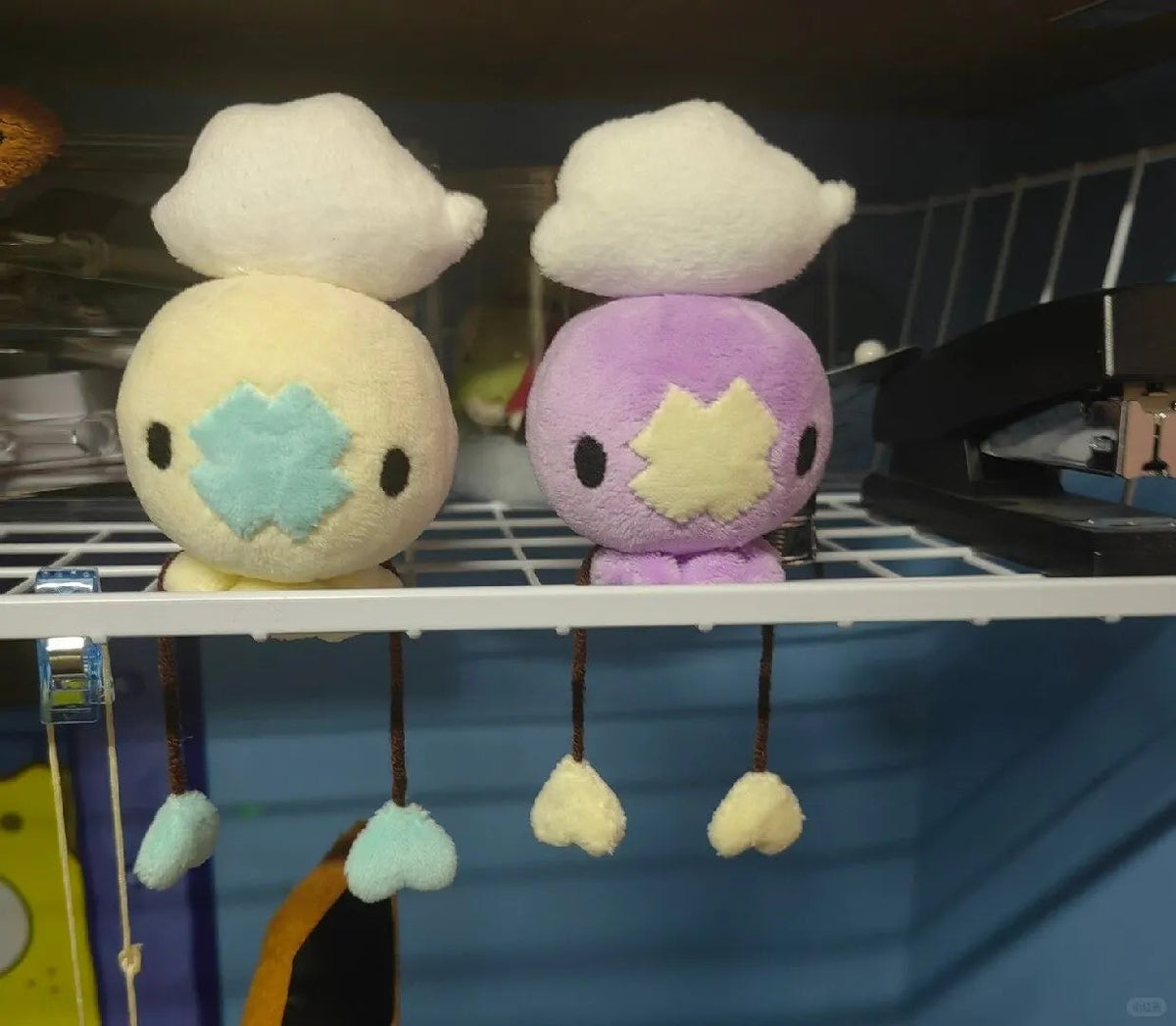 Yellow and lavender Drifloon plush colour variations displayed together
