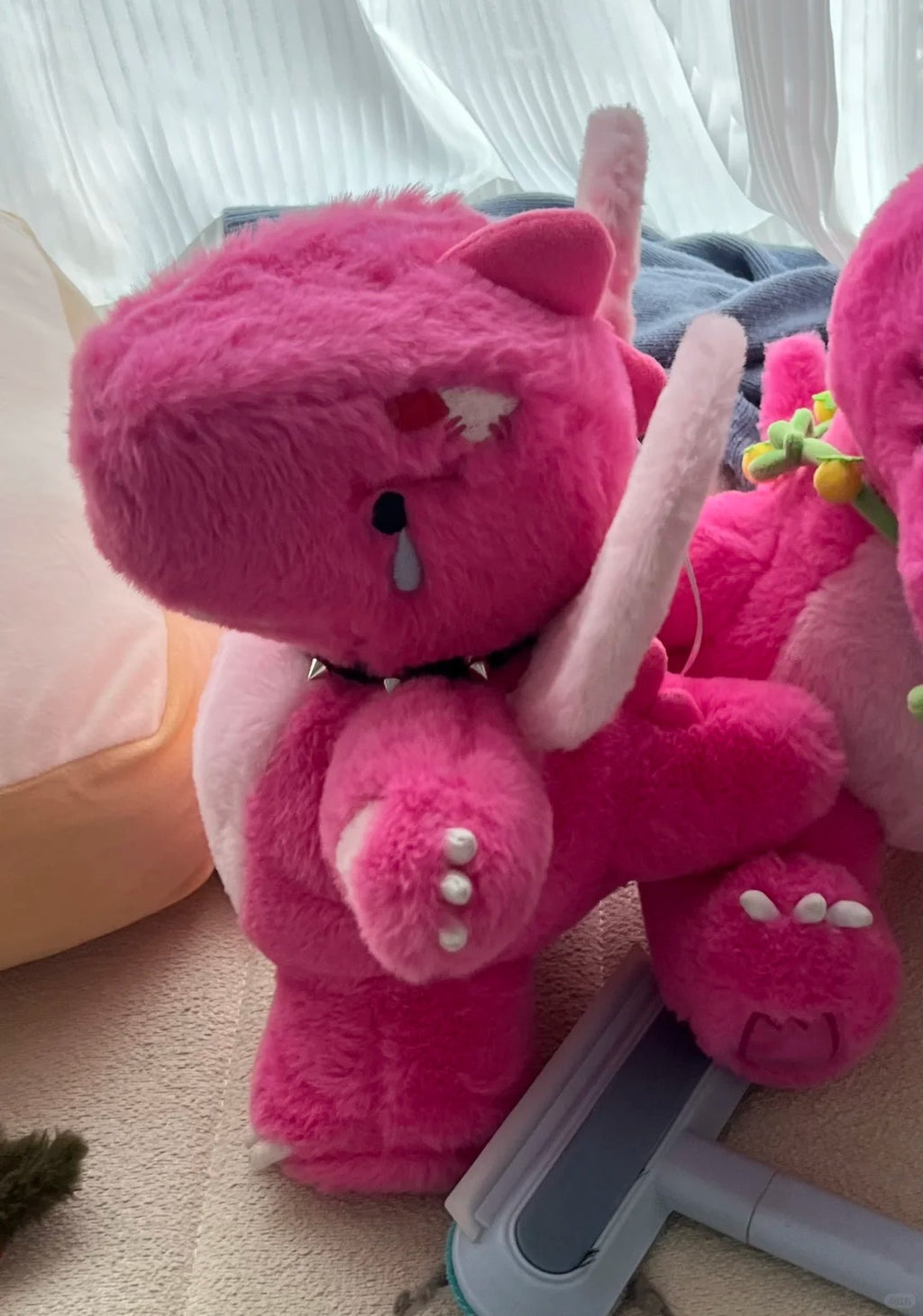 Front view of a seated pink Boltusk elemental dragon plush with tusks and spiked collar