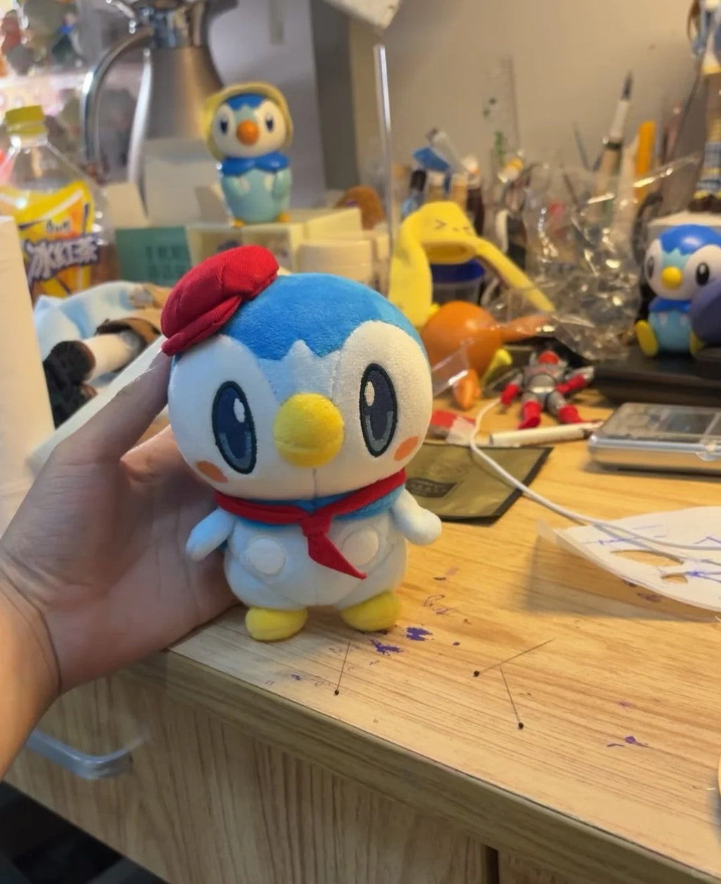 Front view of a handmade café Piplup penguin plush doll