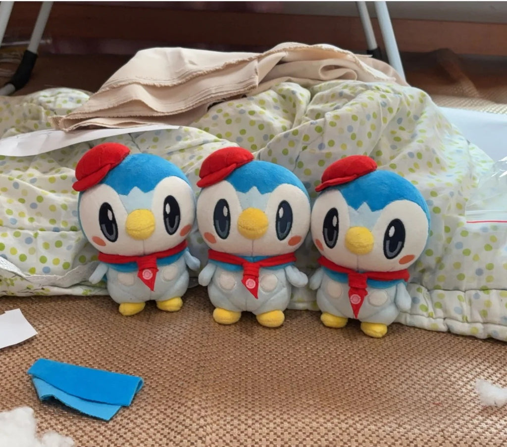 Three handmade café Piplup plush dolls wearing red berets and neck scarves