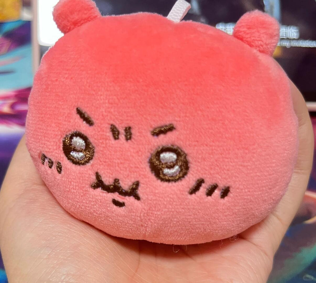 Pink Chiikawa-inspired angry plush shown from a slight side angle in hand