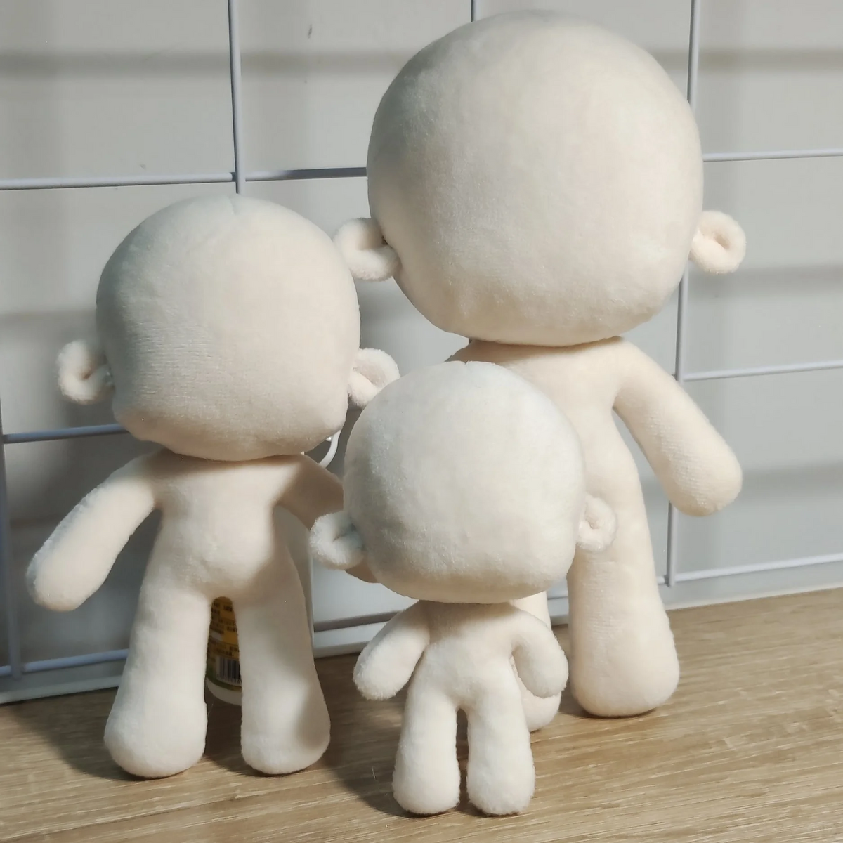 Three blank plush doll bases in different sizes