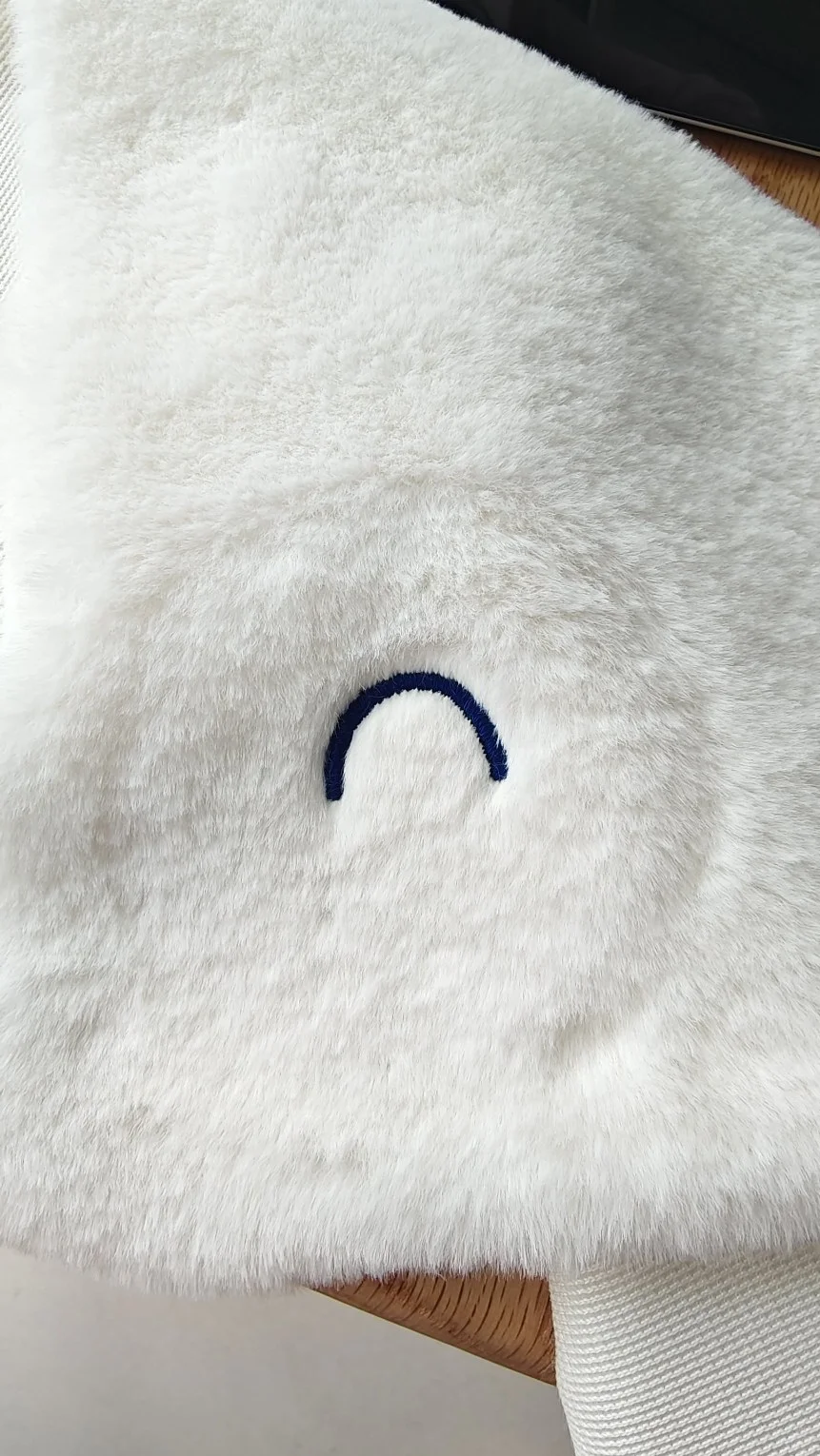 Close-up embroidery detail for Piplup plush face