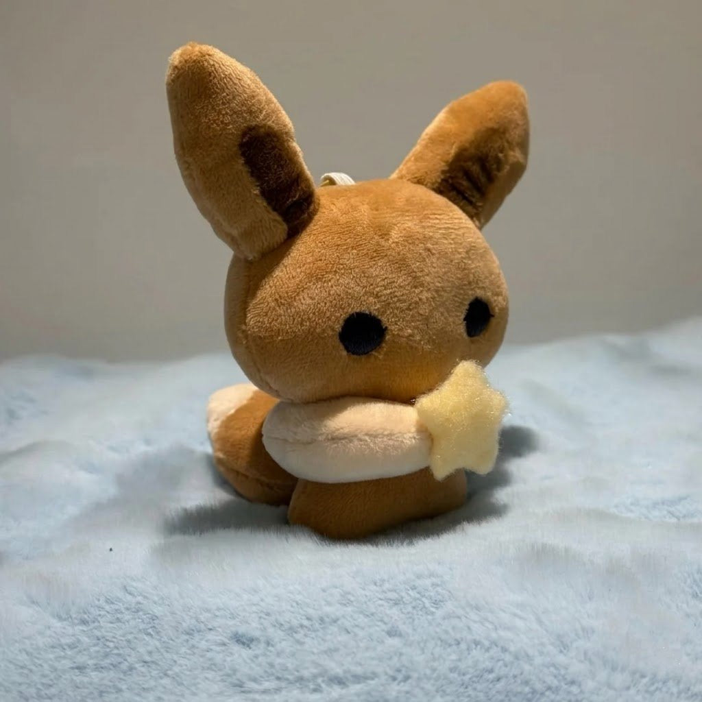 Eevee plush sewing pattern PDF featuring a handmade Eeveelution plush toy with a star accessory Pokemon inspired Eevee plush sewing pattern with PDF template and step by step tutorial