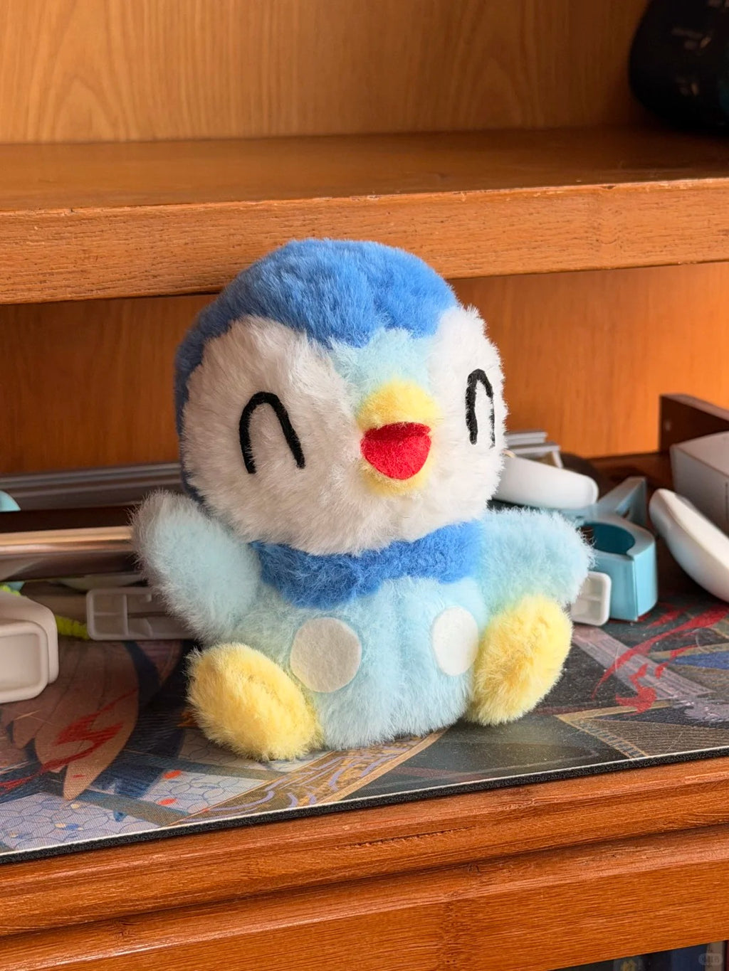 Finished Piplup plush sewing project displayed on a wooden desk