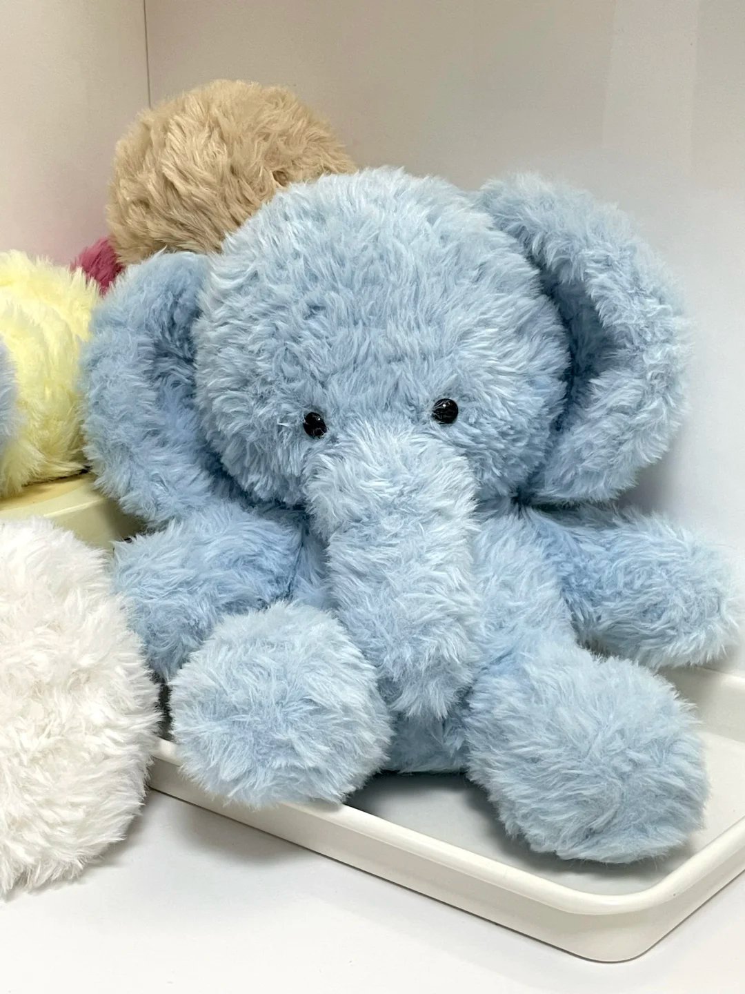 Handmade light blue elephant soft toy sewn from fluffy plush fabric