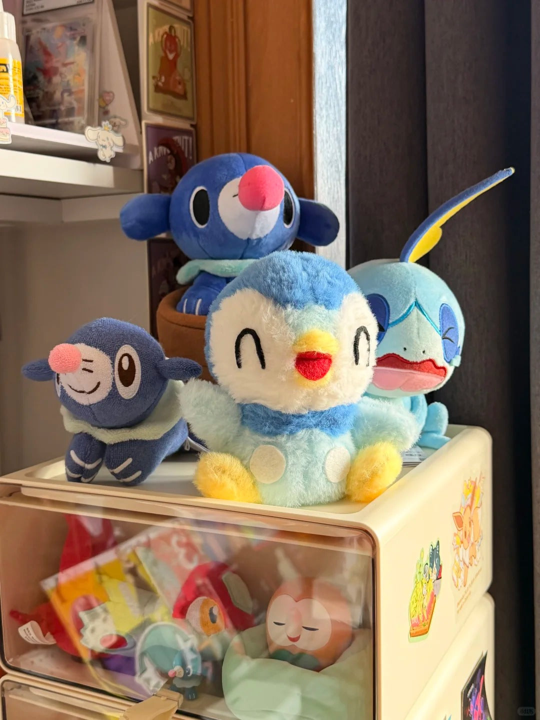 Handmade Piplup plush displayed with a collection of blue Pokémon plush toys