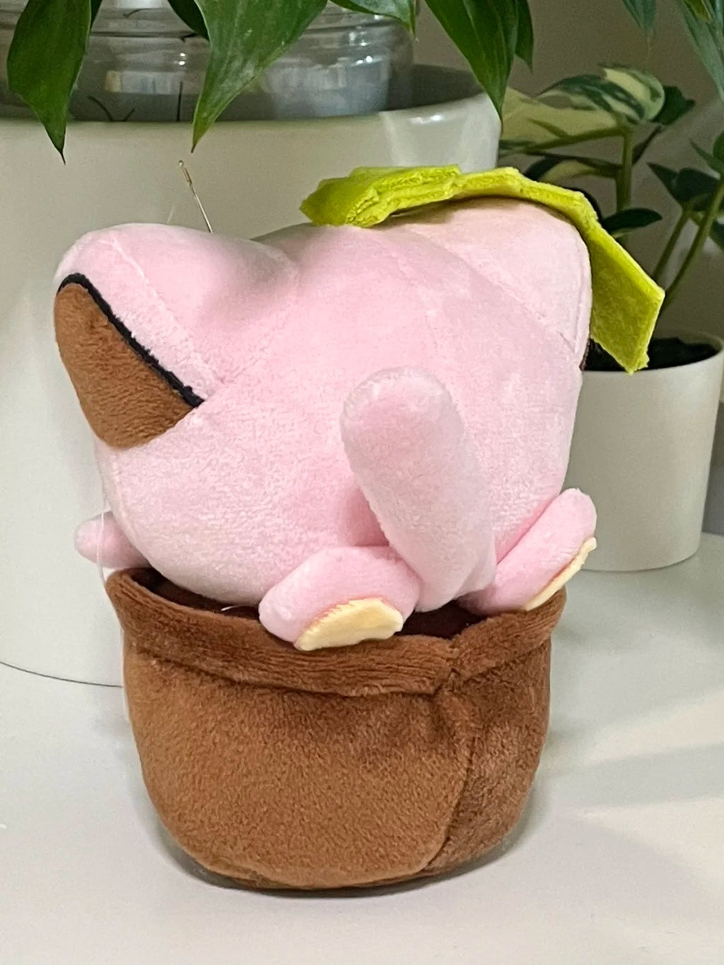 Back view of a handmade pink cat plant plush and removable brown fabric pot
