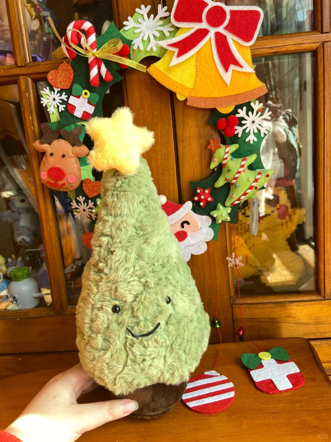 Plush avocado toy with Christmas decorations in the background