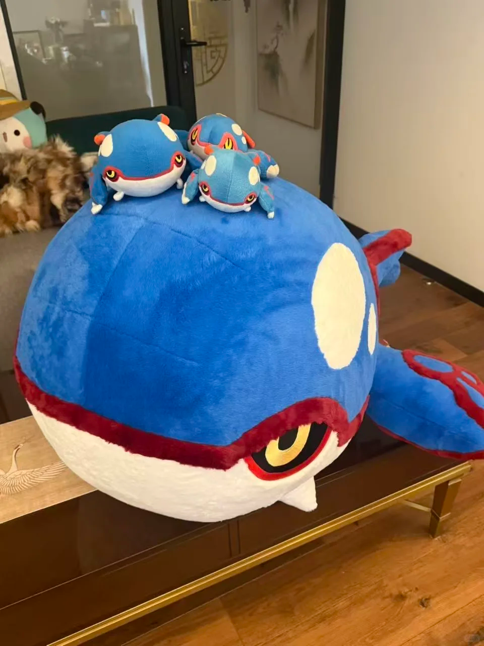 Large handmade Kyogre plush with three smaller Kyogre plushies displayed on top