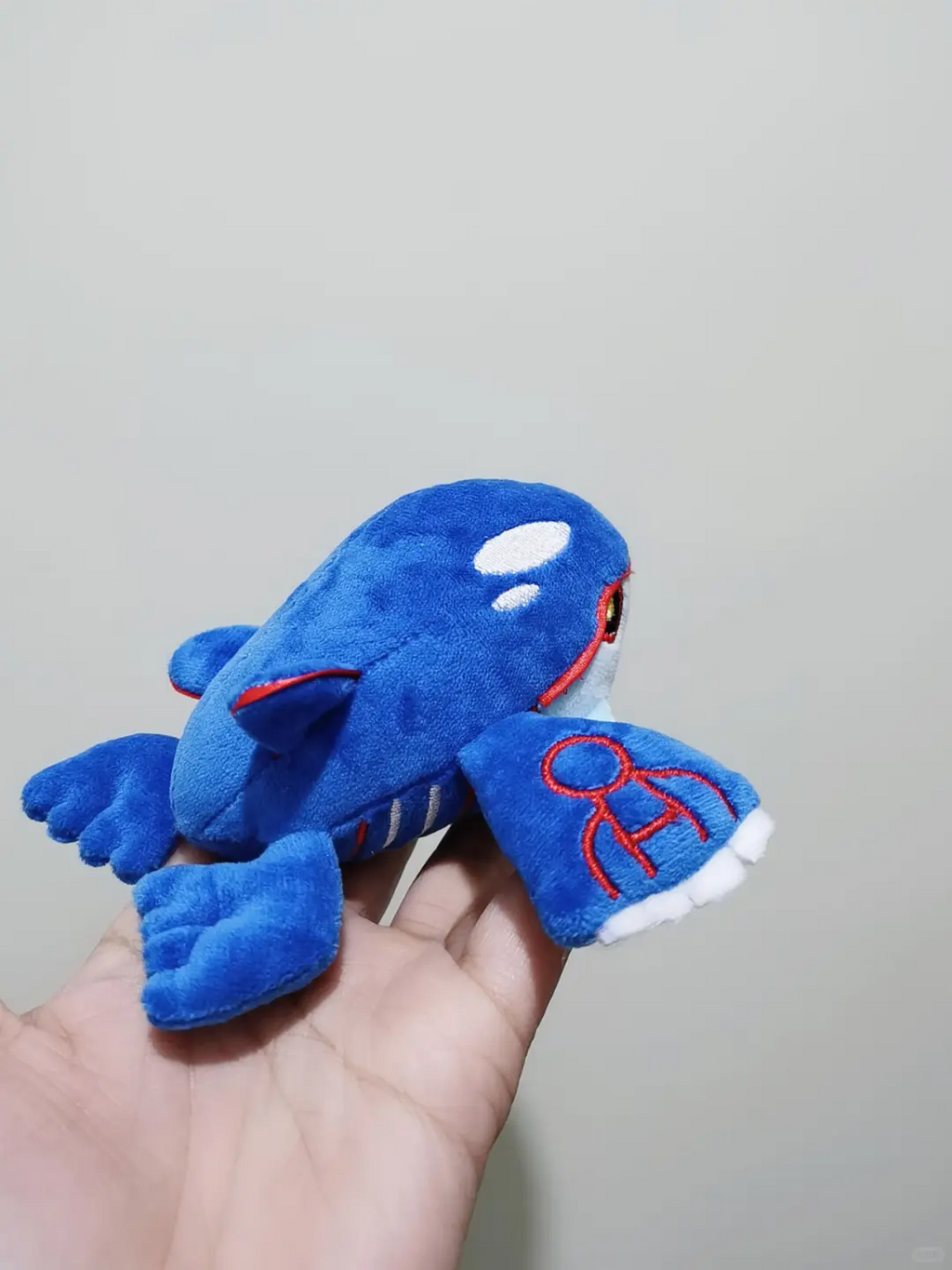 Rear three-quarter view of a handmade blue Kyogre plush sewing project