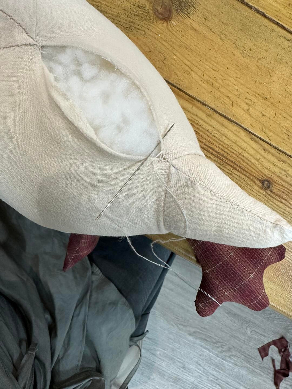 Hand sewing the stuffed goose body after adding filling