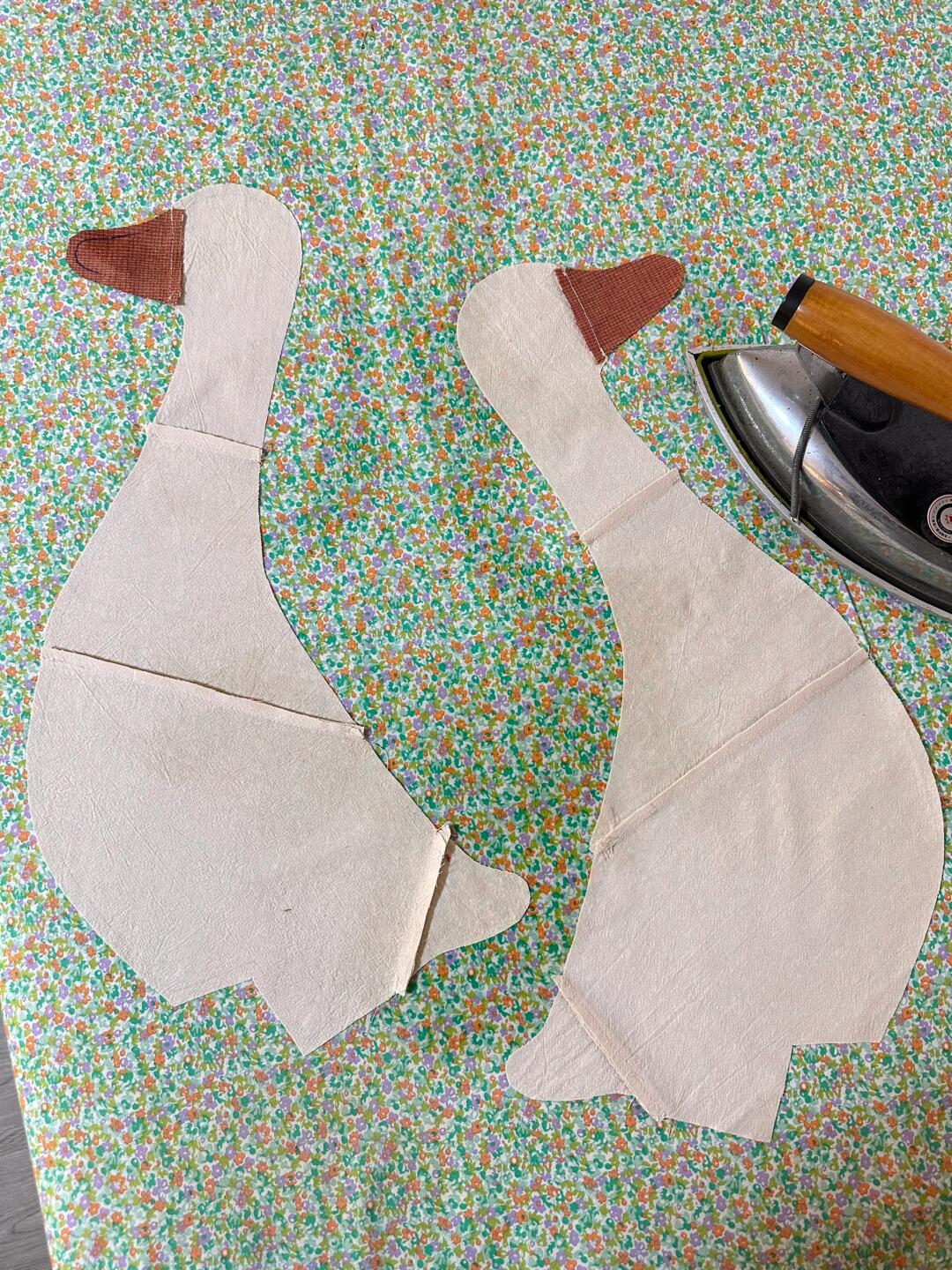 Fabric goose body pieces with attached beaks before assembly