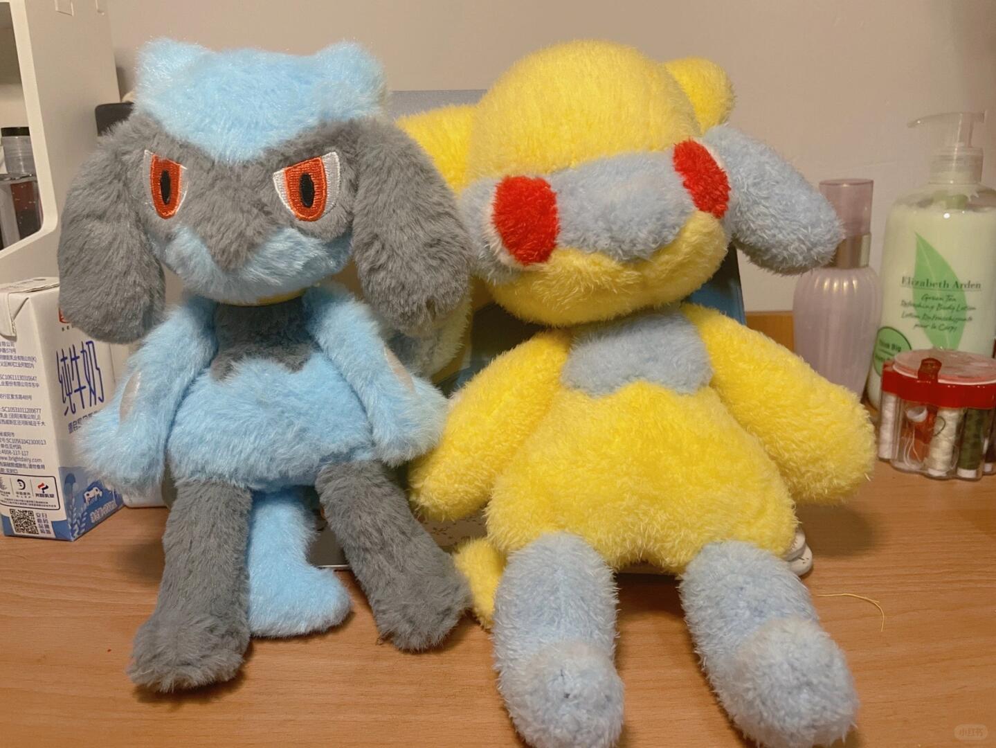 Two large handmade Lucario-inspired plush prototypes in blue and yellow colour variations