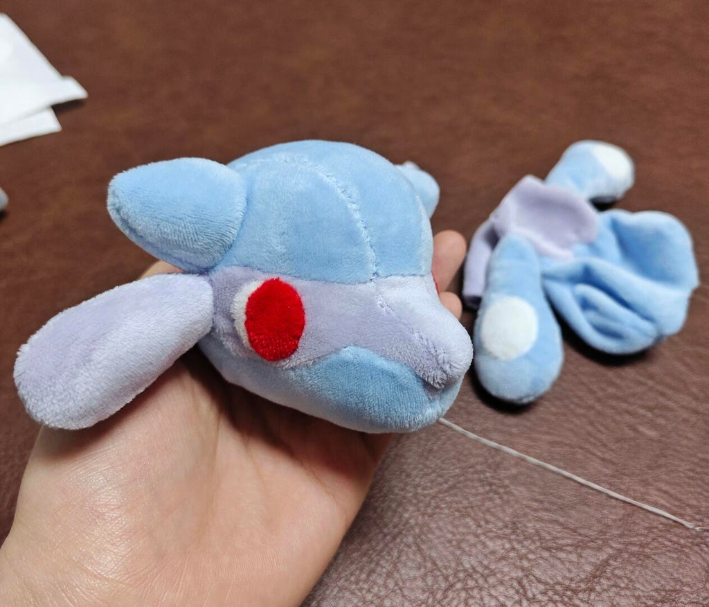 Lucario-inspired plush head and body pieces during assembly, showing the hand-sewn construction process