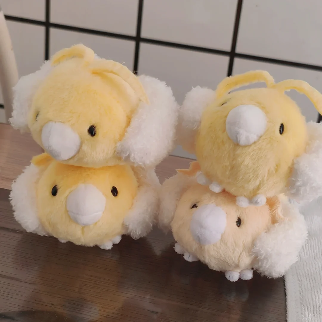 Four handmade yellow Swablu plush toys stacked together
