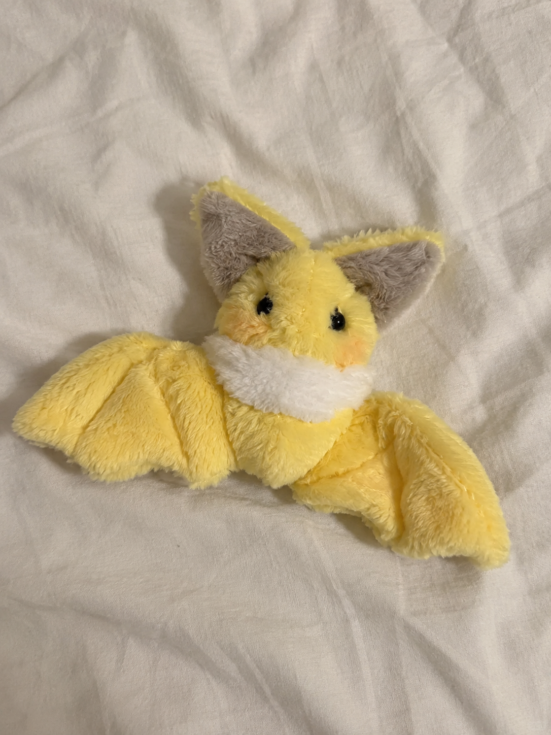 Handmade yellow bat plush sewing pattern finished example on fabric